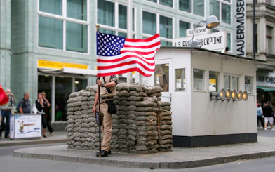 Checkpoint Charlie guard post with American flag, Berlin, part of Guided Bike Tour: Third Reich & The Wall.