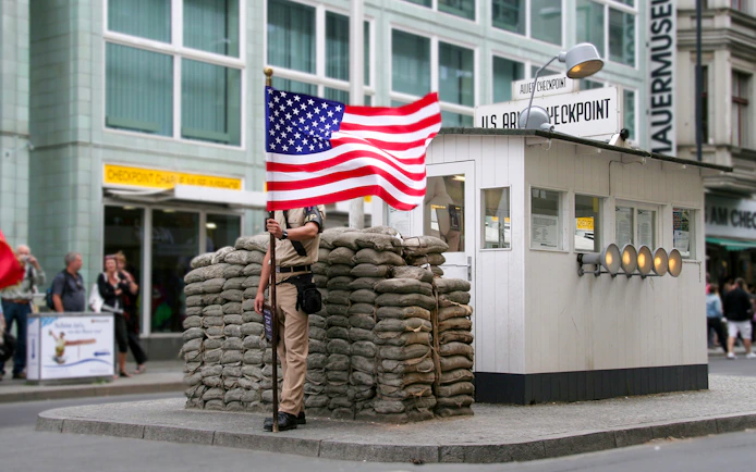 Checkpoint Charlie guard post with American flag, Berlin, part of Guided Bike Tour: Third Reich & The Wall.