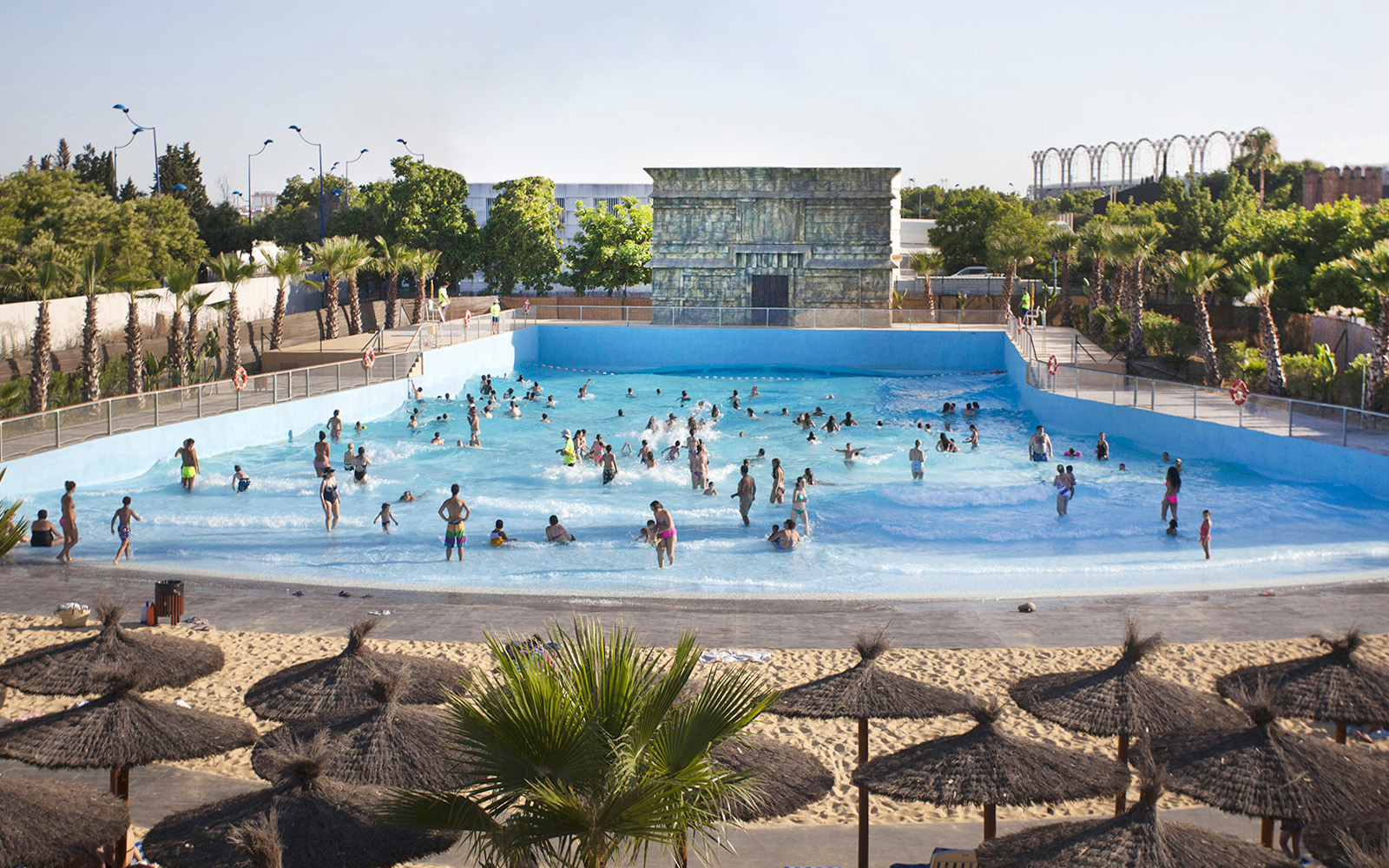 Visitors enjoying the wave pool at Agua Mágica, Isla Mágica, Seville.