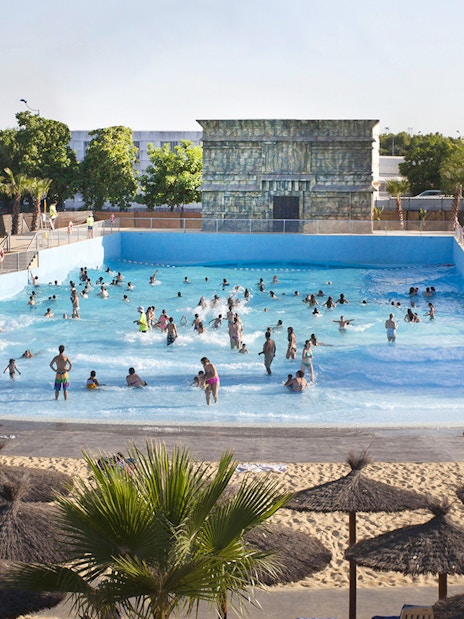 Visitors enjoying the wave pool at Agua Mágica, Isla Mágica, Seville.