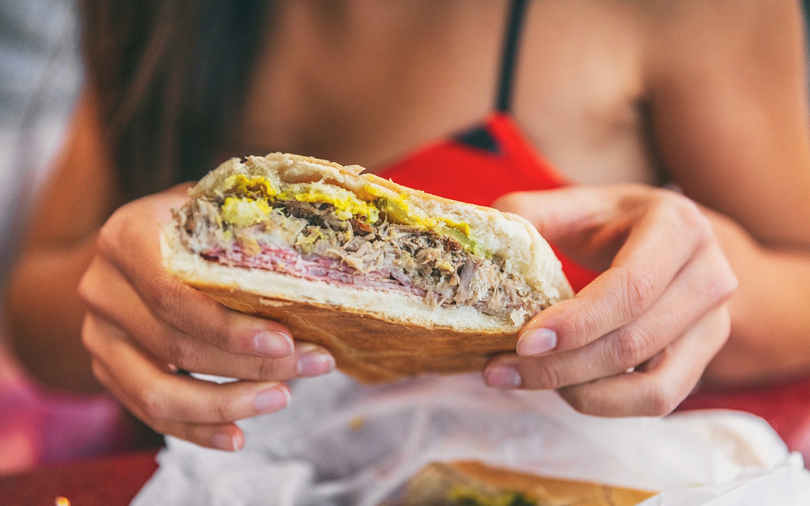 women holding Cuban sandwich