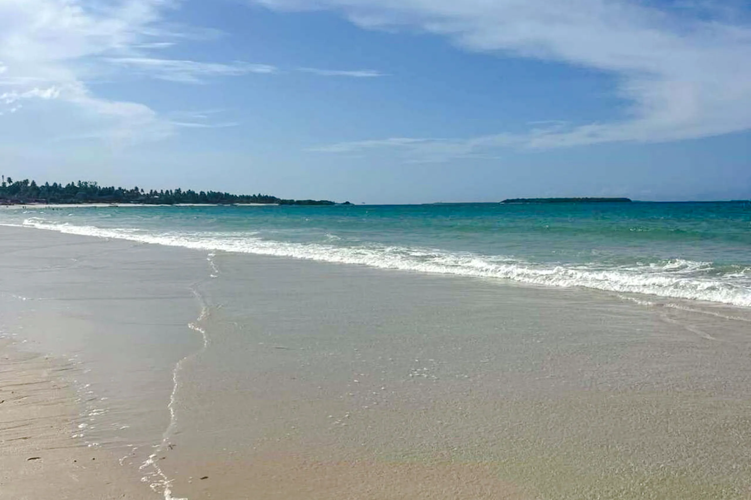 Sandy beach with clear blue water in Dar es Salaam, Tanzania, near Zanzibar.