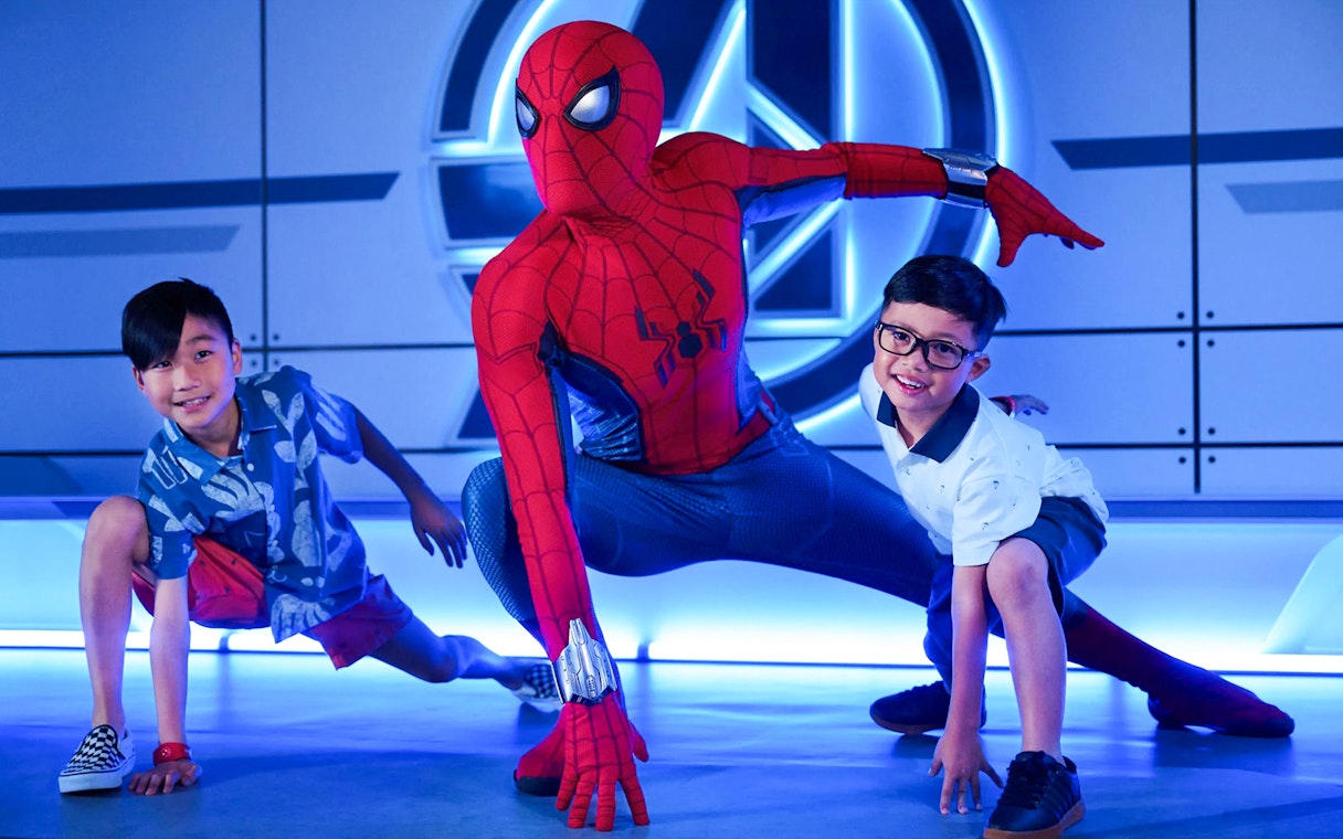 Children posing with superhero character on Disney Adventure Cruise from Singapore.