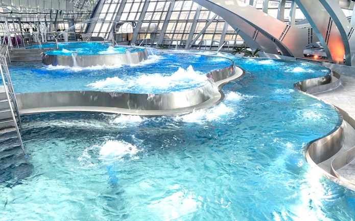 Thermal pools with modern architecture at Caldea spa complex, Andorra.