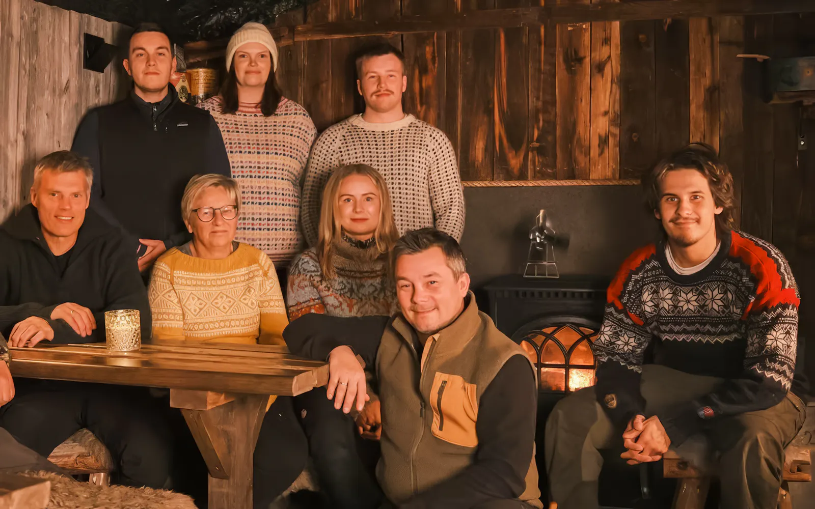 Small group of people in a cozy cabin during a snowmobile day trip in Tromso.
