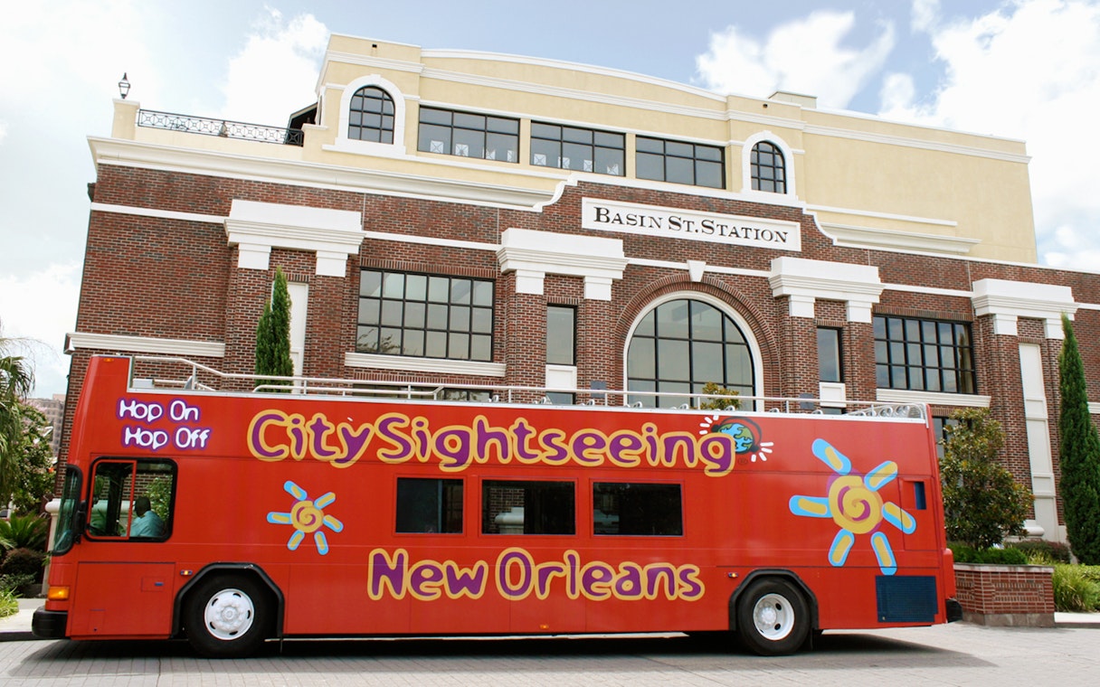 Red City Sightseeing bus in front of Basin St. Station, New Orleans.