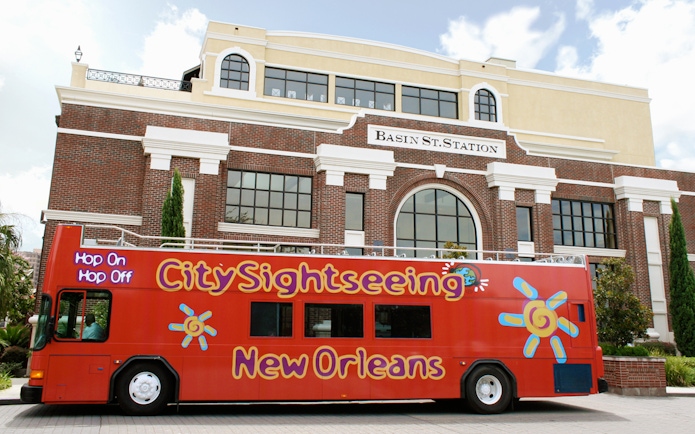 Red City Sightseeing bus in front of Basin St. Station, New Orleans.