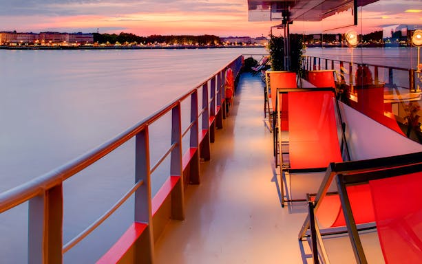Deck view of Bateaux Bordelais Dinner Cruise at sunset on the Garonne River, Bordeaux.