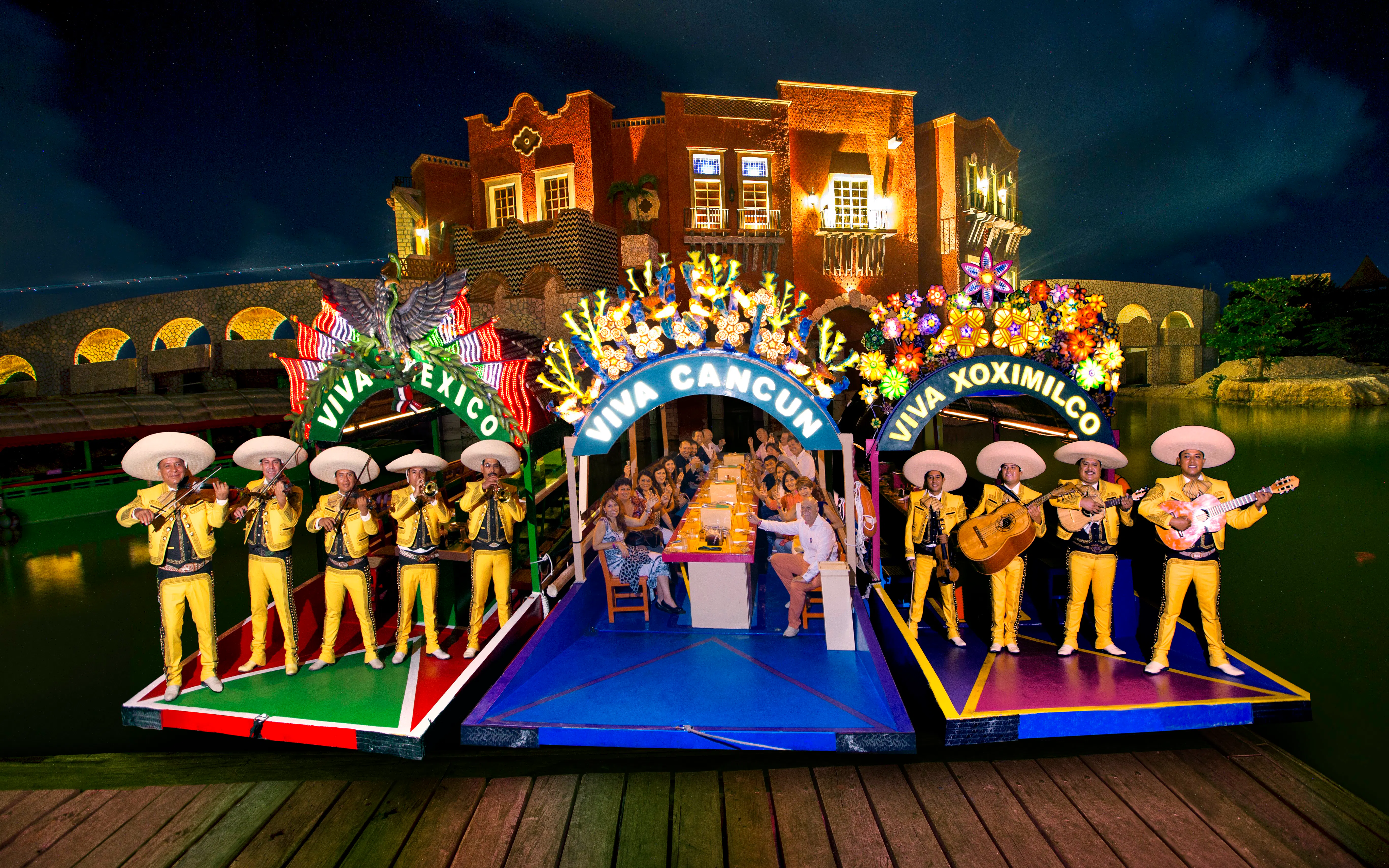 Mariachi band performing on colorful boats at Xoximilco Park, Cancun.