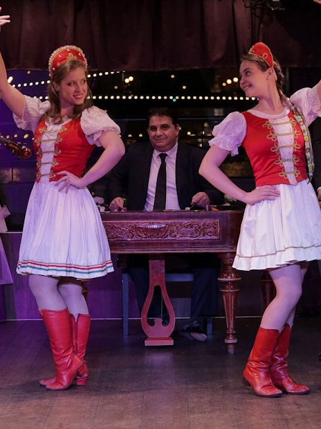 Musicians and dancers performing traditional folk show on Budapest dinner cruise.