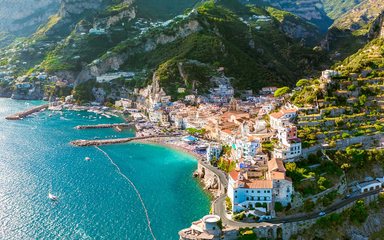Aerial view of Amalfi Coast with colorful buildings and turquoise sea on a day trip.