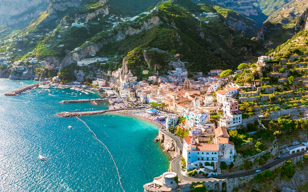 Aerial view of Amalfi Coast with colorful buildings and turquoise sea on a day trip.