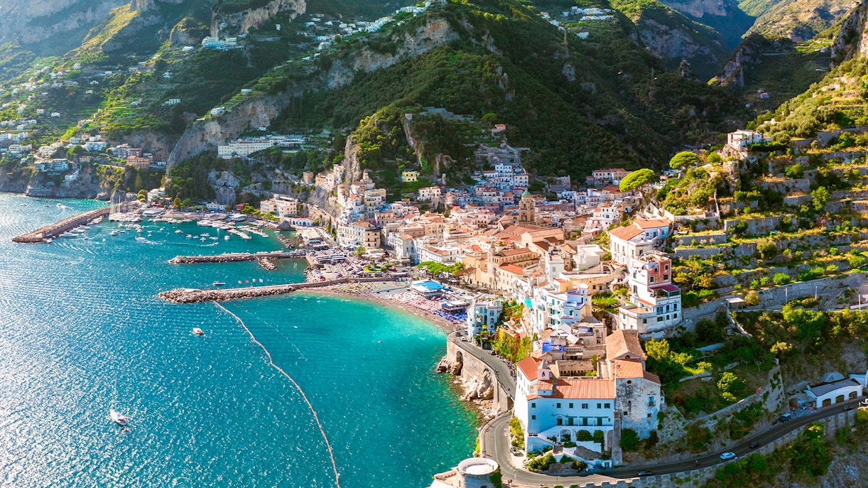 Aerial view of Amalfi Coast with colorful buildings and turquoise sea on a day trip.