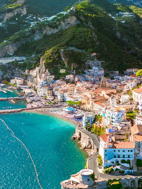 Aerial view of Amalfi Coast with colorful buildings and turquoise sea on a day trip.