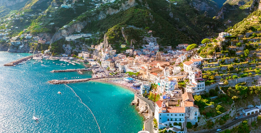 Aerial view of Amalfi Coast with colorful buildings and turquoise sea on a day trip.