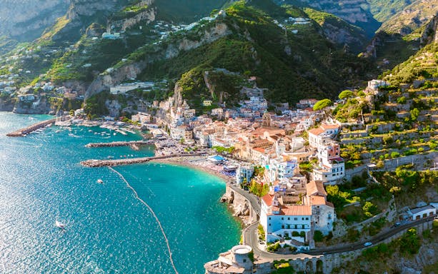 Aerial view of Amalfi Coast with colorful buildings and turquoise sea on a day trip.