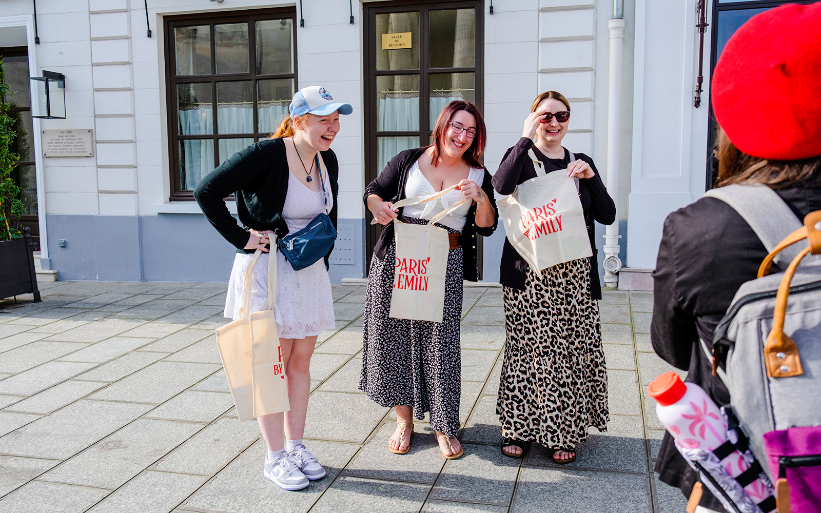 Tourists smiling and holding bags during Emily in Paris Locations Walking Tour.