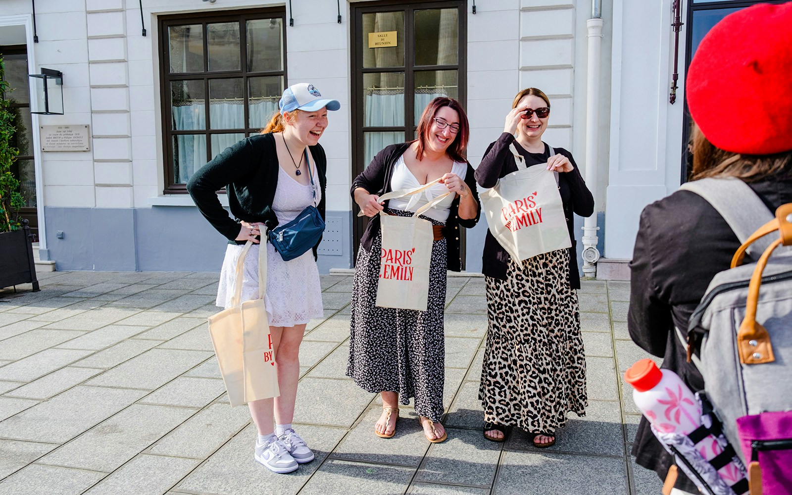 Tourists smiling and holding bags during Emily in Paris Locations Walking Tour.