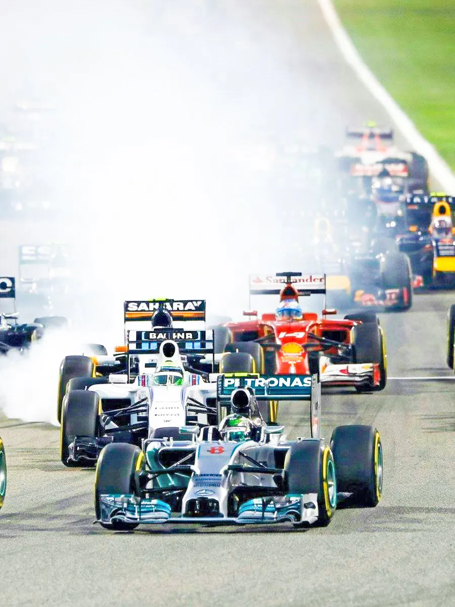 Formula 1 cars racing on track at Malaysia Grand Prix.