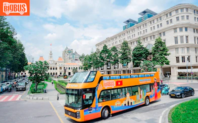Open-top tour bus in front of Ho Chi Minh City Hall on Heritage Sightseeing Loop.