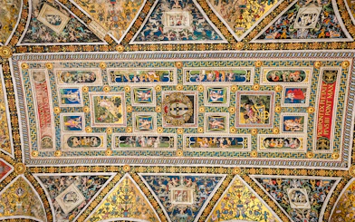 Ceiling frescoes in Piccolomini Library, Siena Cathedral, featuring intricate Renaissance artwork.
