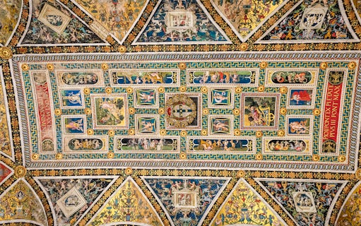 Ceiling frescoes in Piccolomini Library, Siena Cathedral, featuring intricate Renaissance artwork.