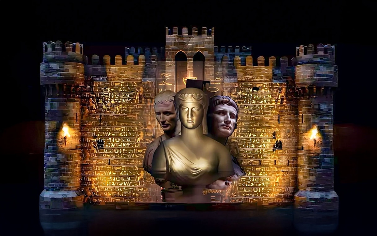 Qaitbay Citadel illuminated with ancient statues projected on its walls.