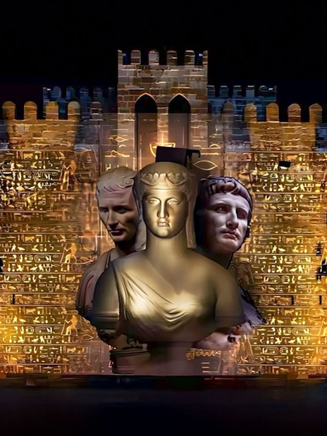 Qaitbay Citadel illuminated with ancient statues projected on its walls.