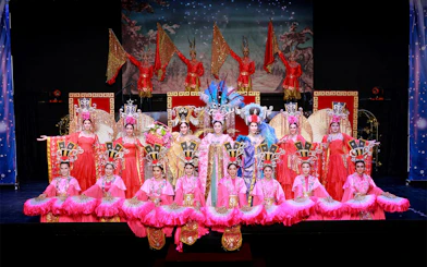 Performers in vibrant costumes on stage at Siam Dragon Cabaret Show, Thailand.