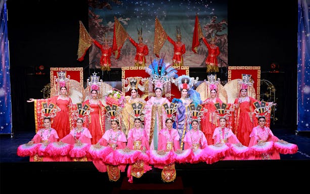 Performers in vibrant costumes on stage at Siam Dragon Cabaret Show, Thailand.