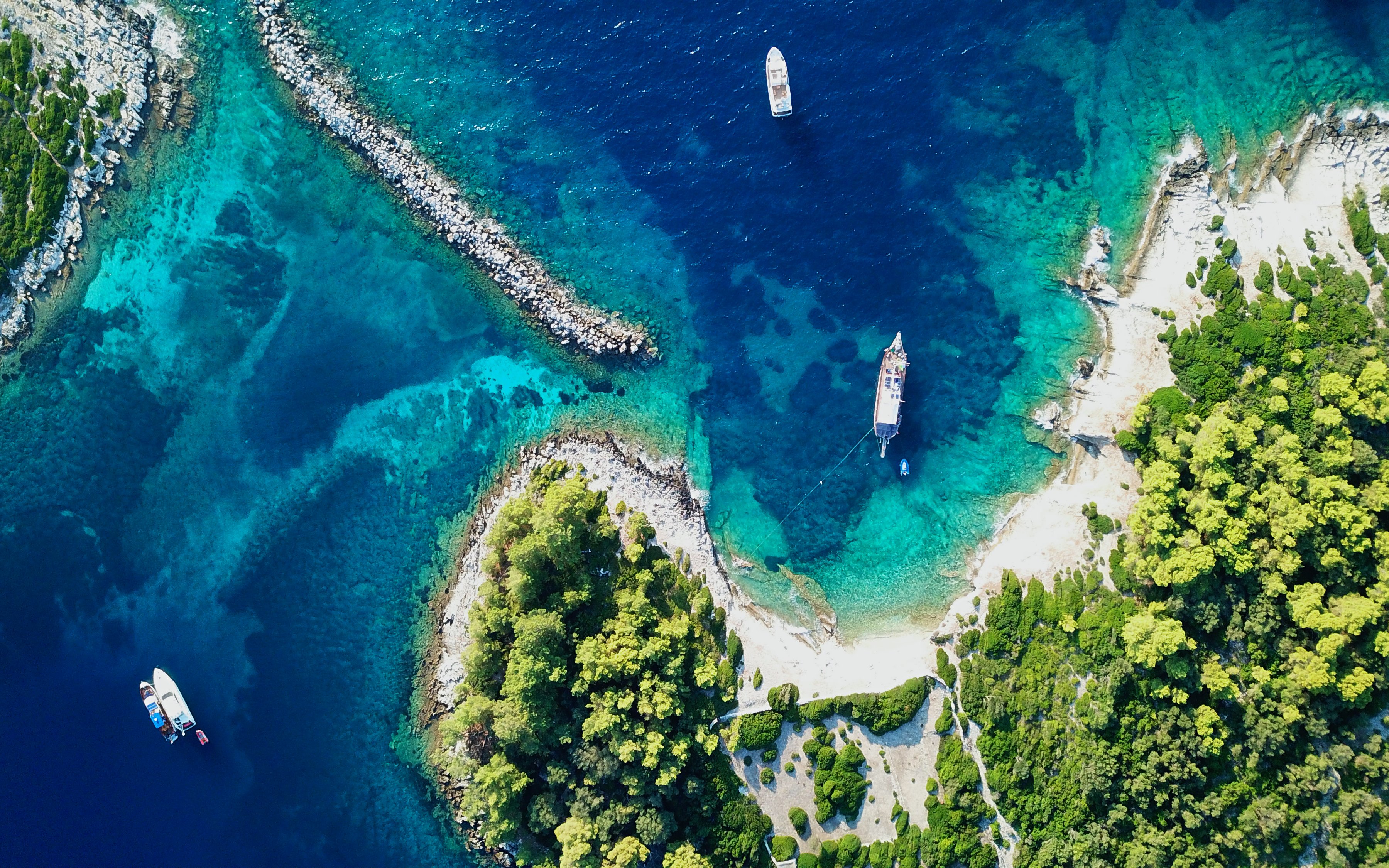 Aerial view of yachts in the clear waters of Gaios harbor, Paxos island, Greece.