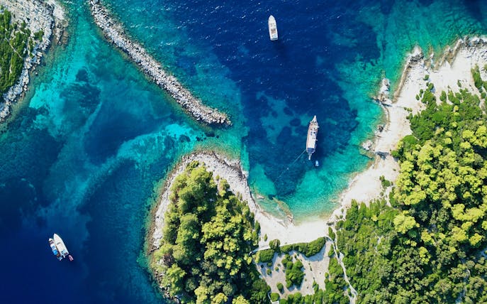 Aerial view of yachts in the clear waters of Gaios harbor, Paxos island, Greece.