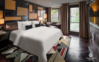 Luxury cabin with a view of Ha Long Bay on a 5-star Ambassador Cruise.