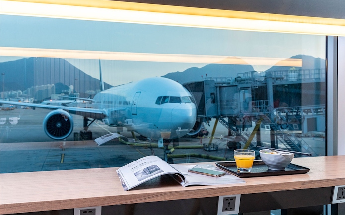 Airplane view from Plaza Premium Lounge with breakfast and magazine.