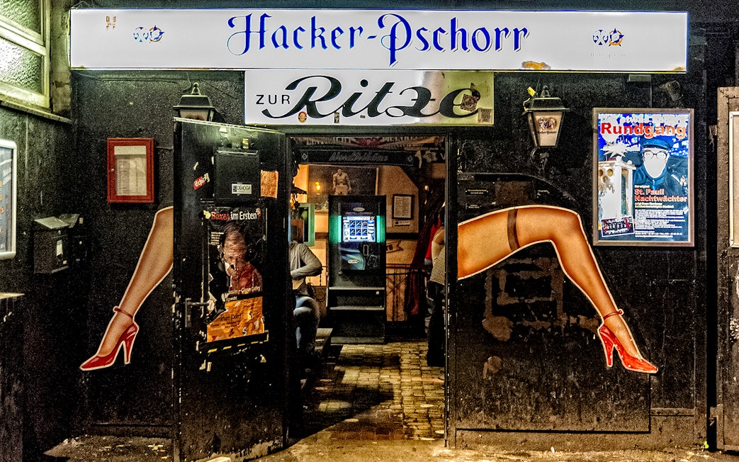 Entrance to Zur Ritze bar in St. Pauli, Hamburg, featuring iconic leg artwork.