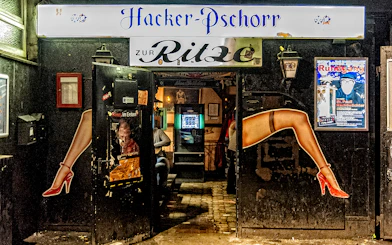Entrance to Zur Ritze bar in St. Pauli, Hamburg, featuring iconic leg artwork.