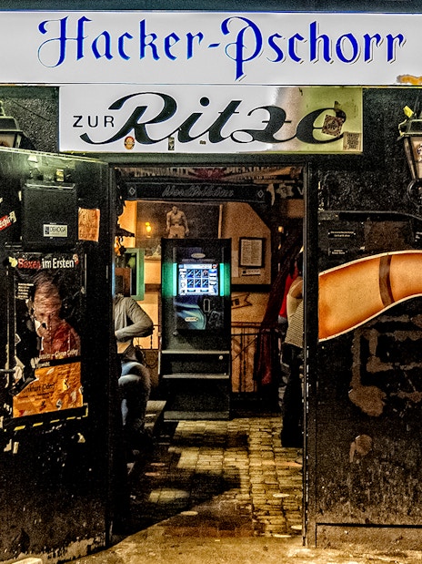 Entrance to Zur Ritze bar in St. Pauli, Hamburg, featuring iconic leg artwork.