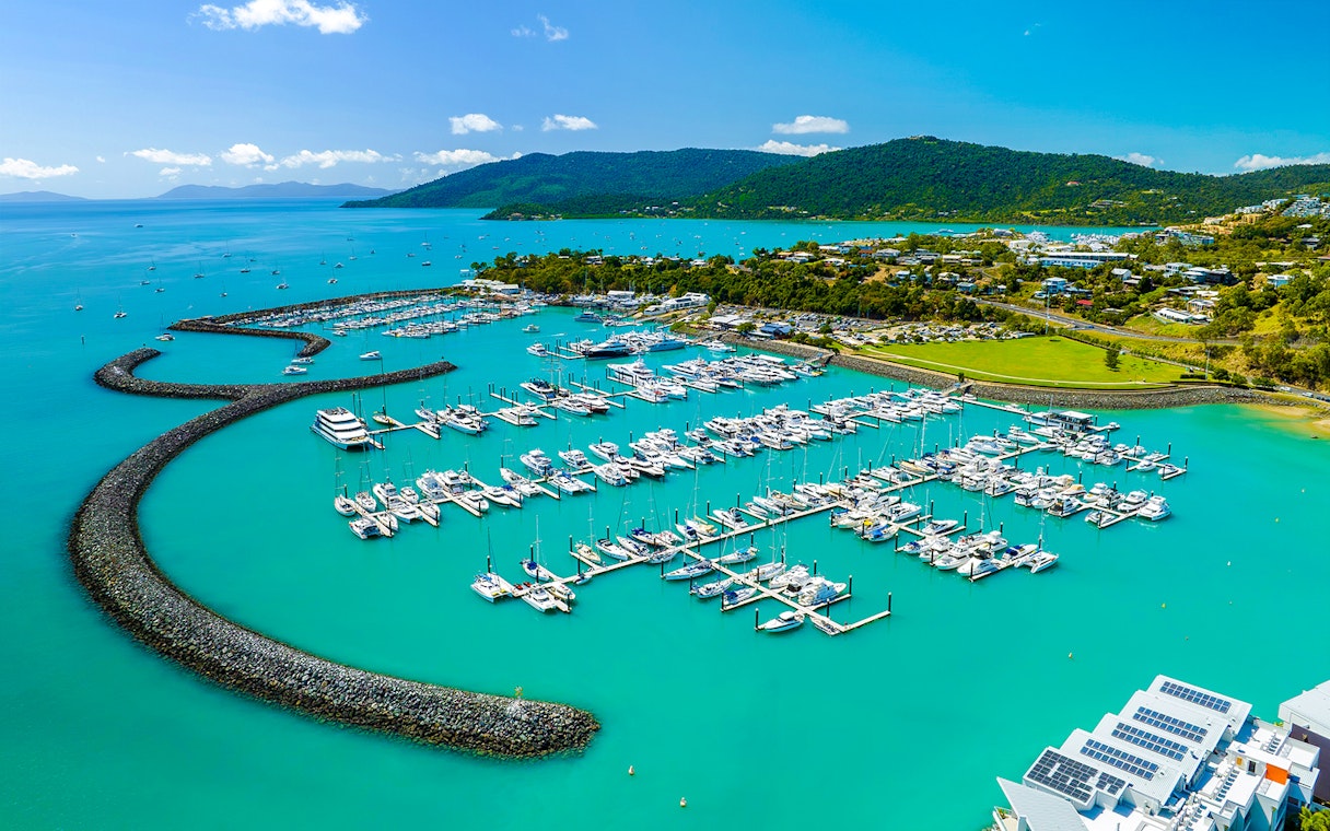 Coral Sea Marina in Airlie Beach with yachts and turquoise waters.