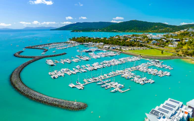 Coral Sea Marina in Airlie Beach with yachts and turquoise waters.