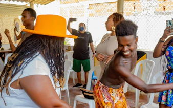 Tourists engaging in a cultural dance workshop, smiling and interacting.