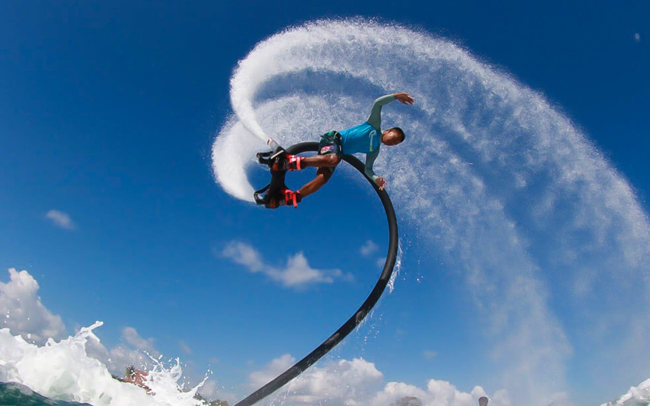 Flyboarder performing aerial trick over water in Hurghada.