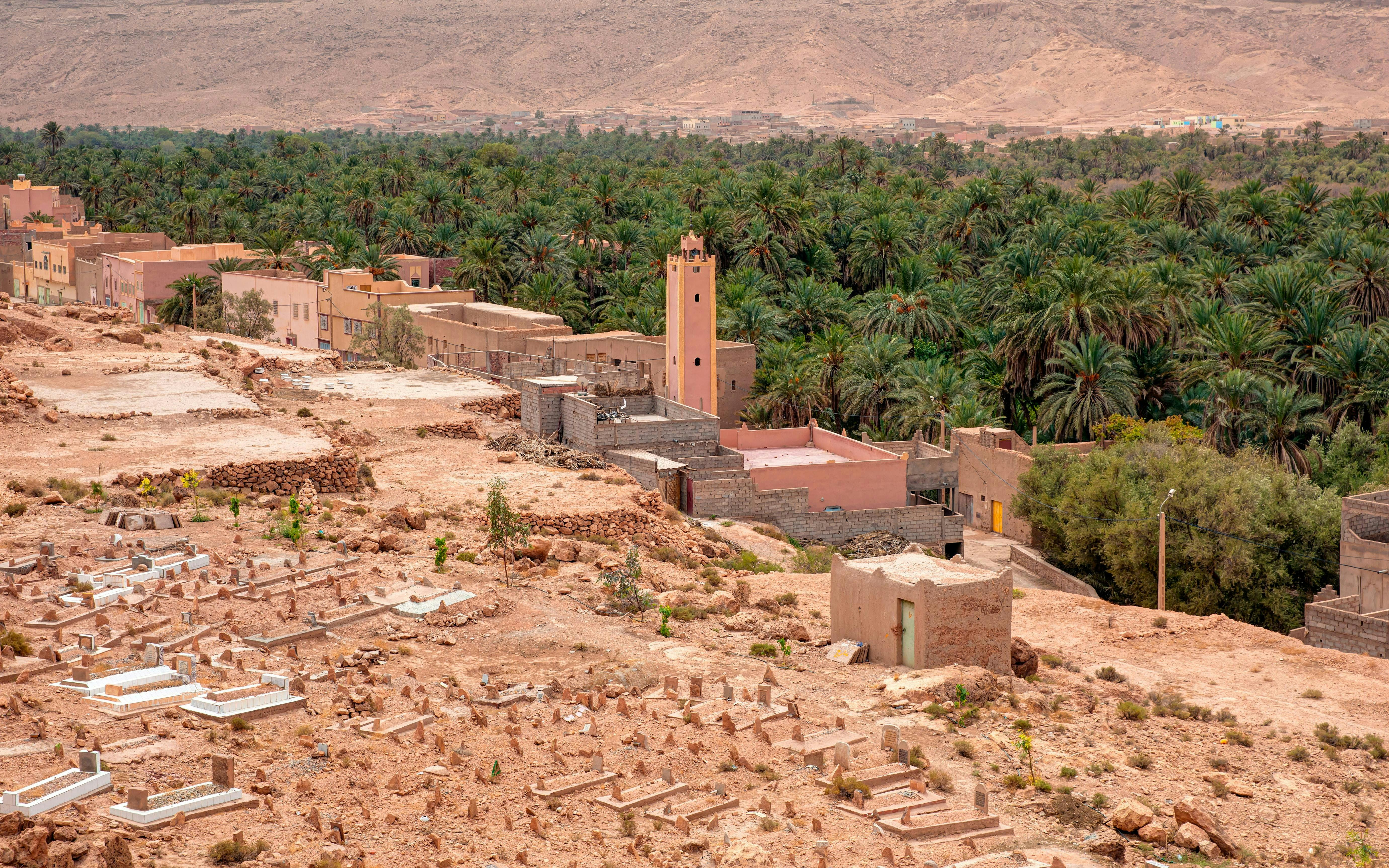 Palm grove and village in Ziz Valley, Morocco, with desert landscape.