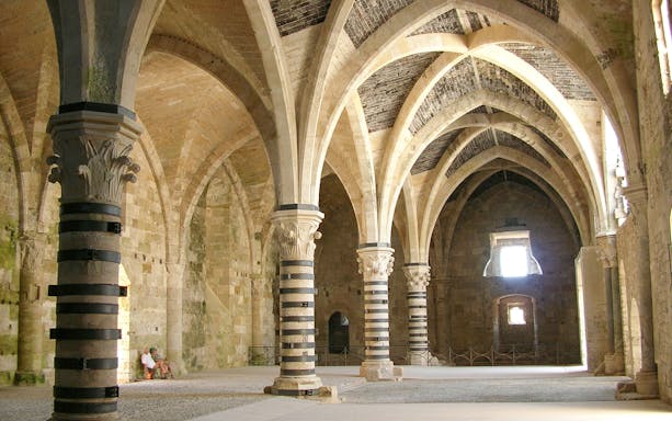Interior arches and columns of Maniace Castle in Syracuse, Italy.