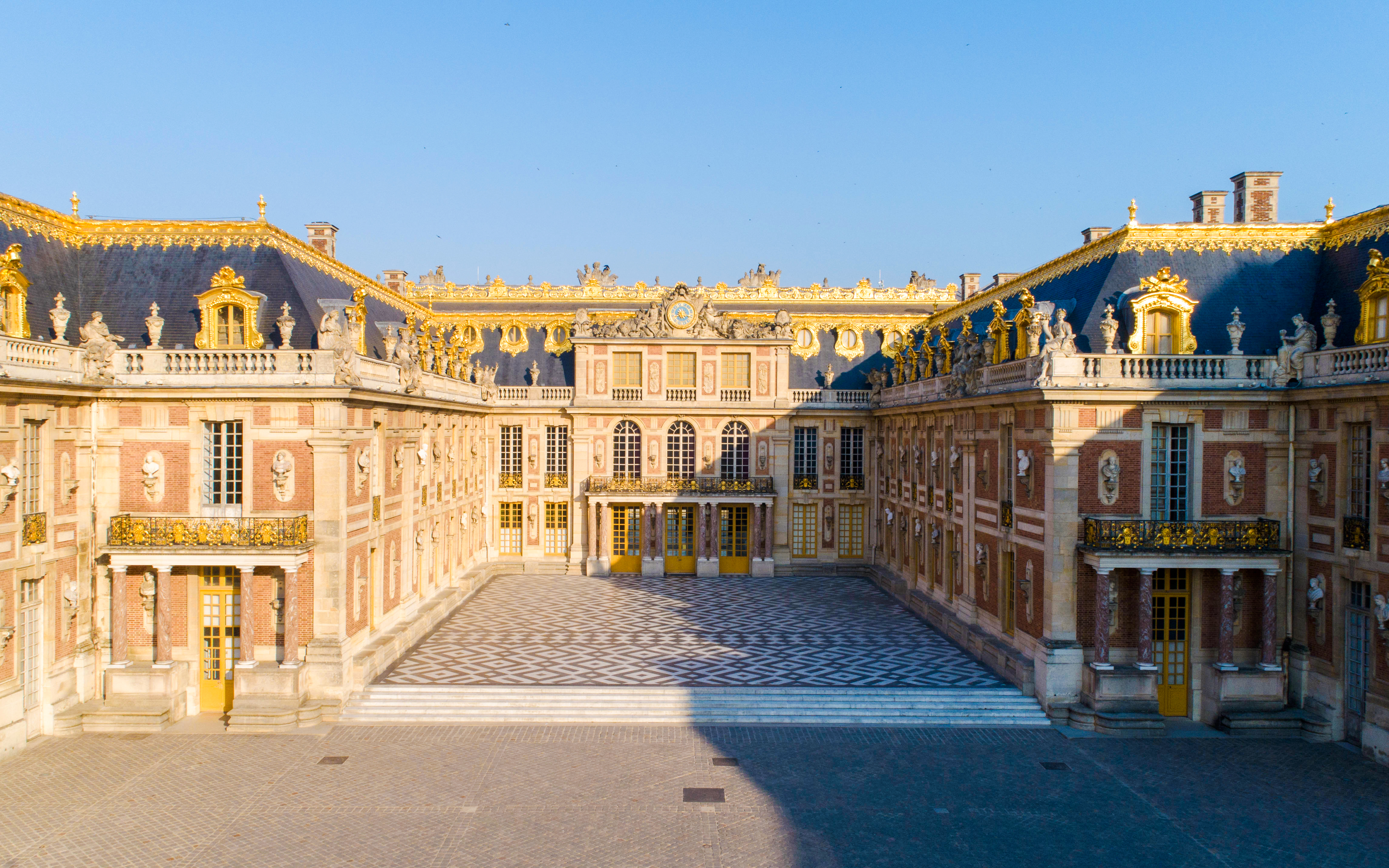 Versailles Palace facade illuminated at dusk, Paris.