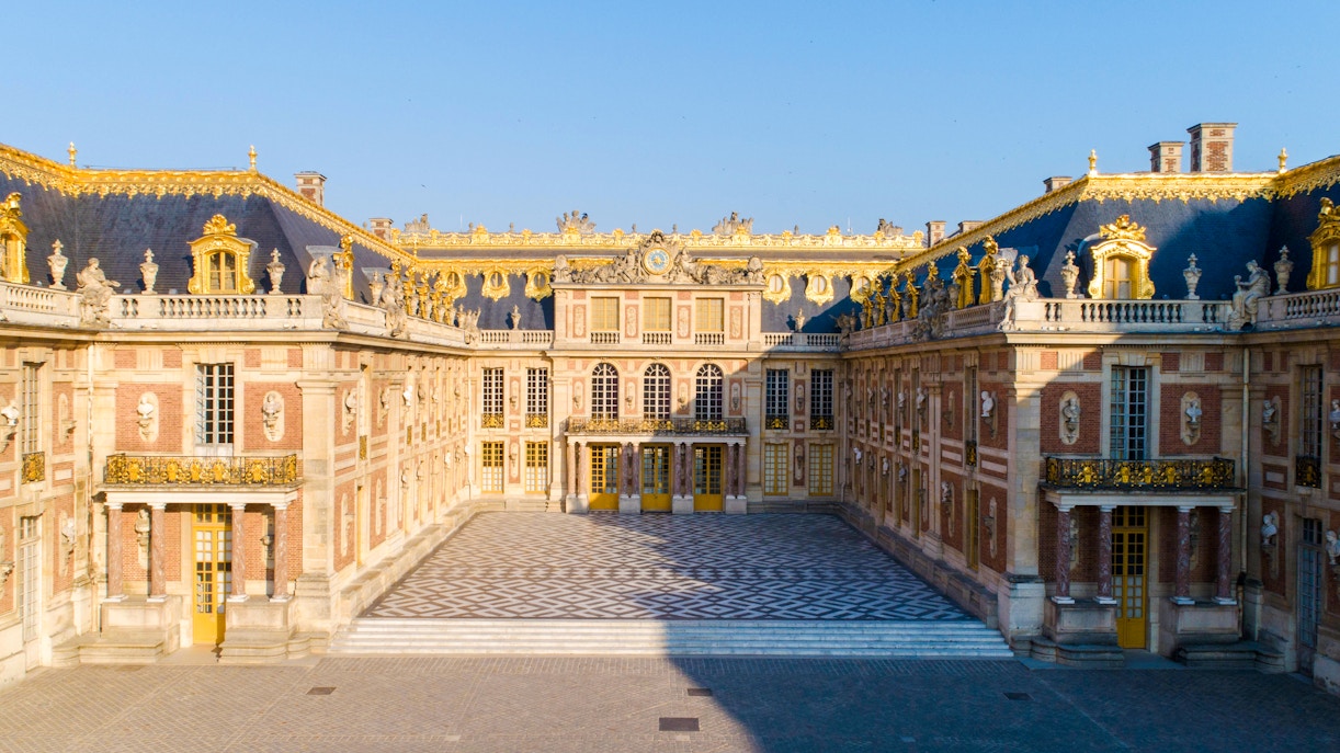 Versailles Palace facade illuminated at dusk, Paris.