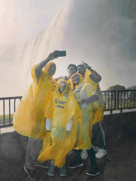 Visitors in yellow ponchos taking a selfie near Niagara Falls, Canada.
