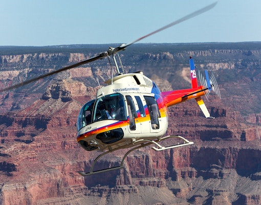 Group of tourists enjoying the breathtaking view of the Grand Canyon South Rim during a guided tour