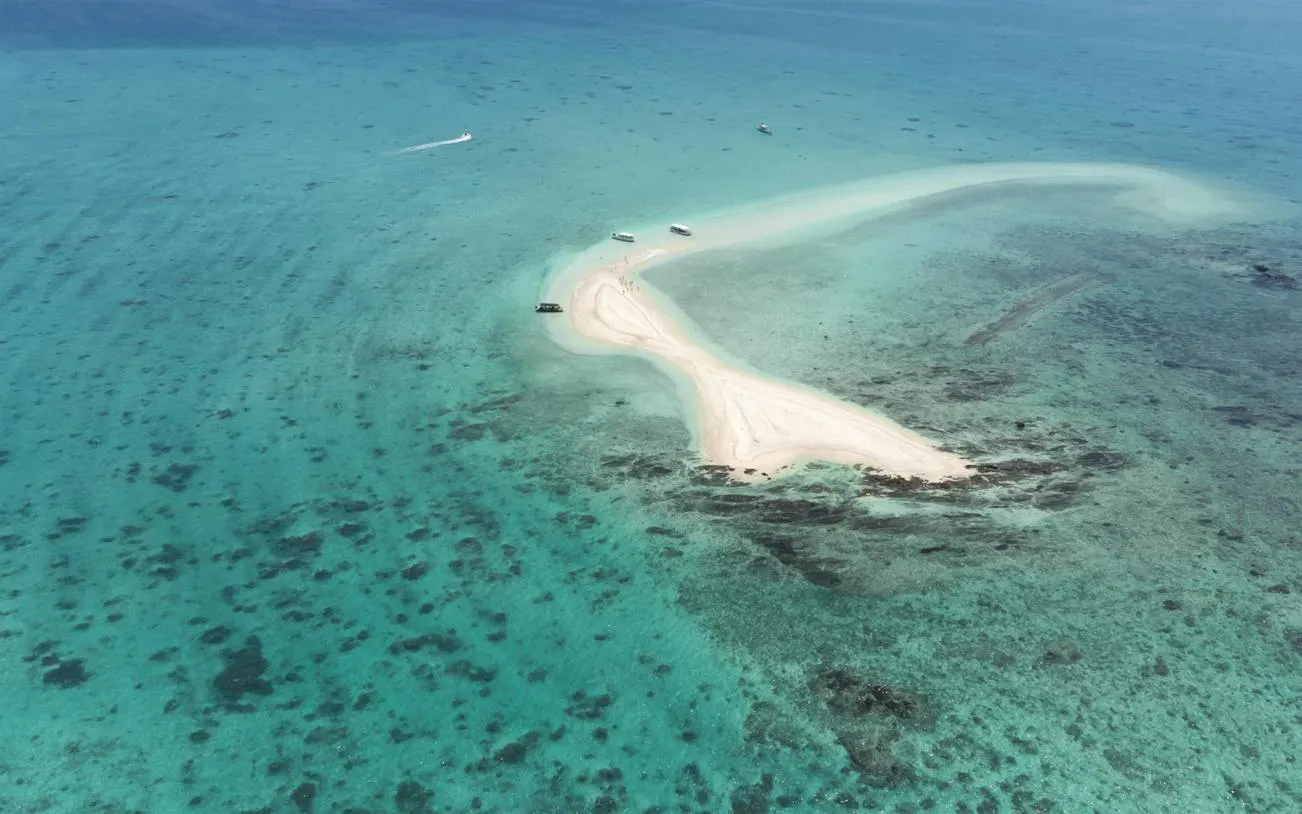 Aerial view of Phantom Island's sandbar in Ishigaki, Okinawa, surrounded by turquoise waters.