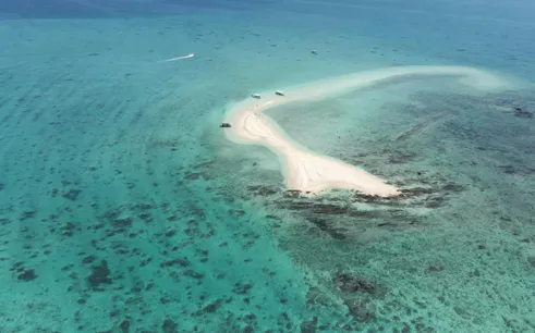 Aerial view of Phantom Island's sandbar in Ishigaki, Okinawa, surrounded by turquoise waters.