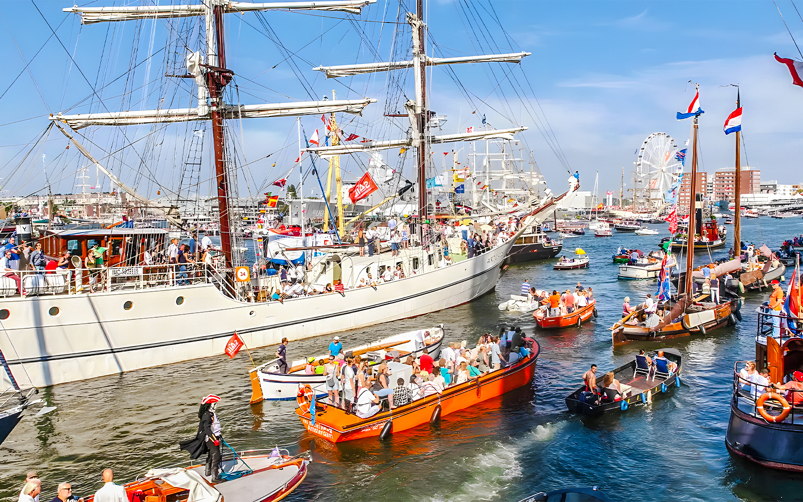 Tall ships sailing in Amsterdam harbor during SAIL Amsterdam event.